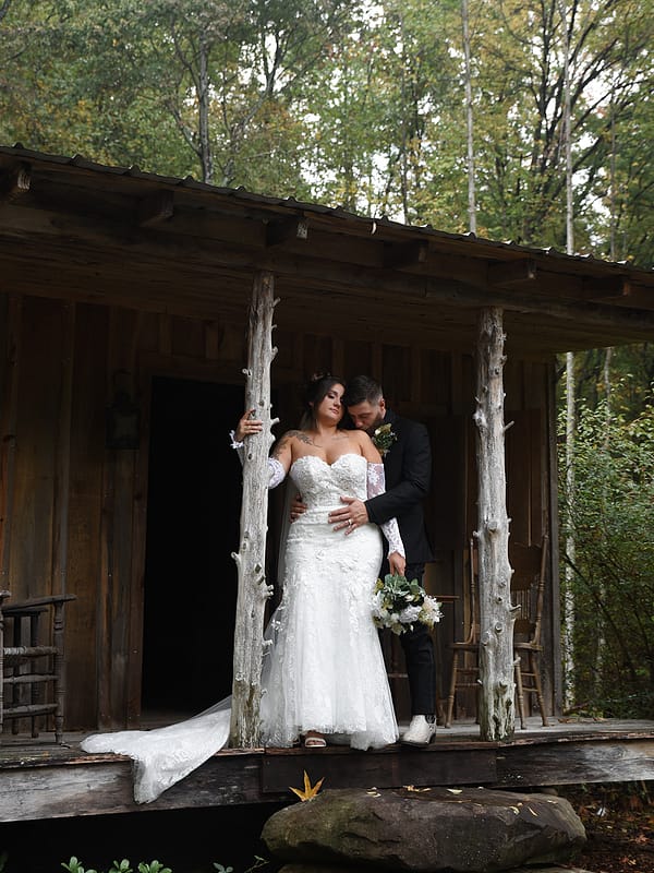 Andrea and Noah on a rustic wooden porch — Mountain Willow Manor wedding