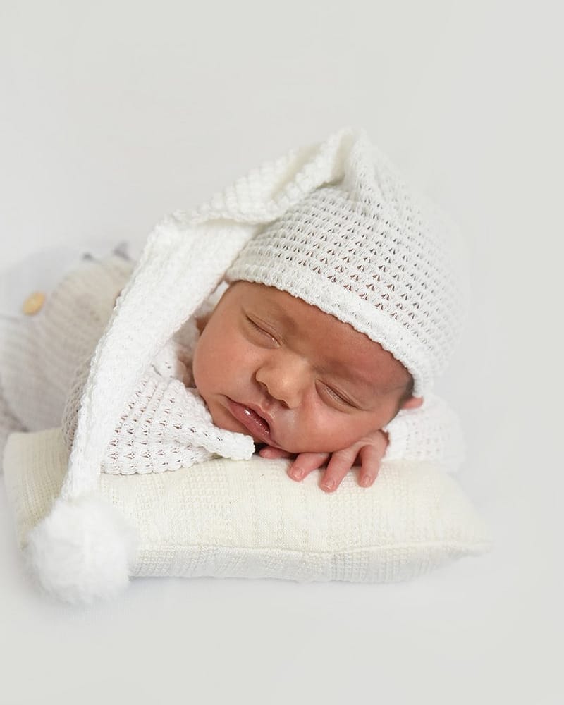 Studio newborn portrait with knit hat